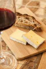 Close up of red wine served with cheese and bread 