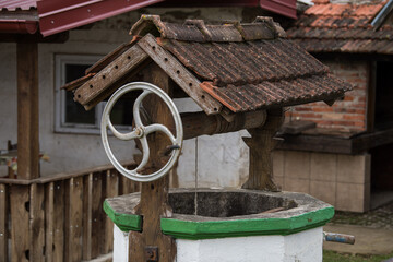 An old well at the farm. Well for drawing water located in the countryside.
