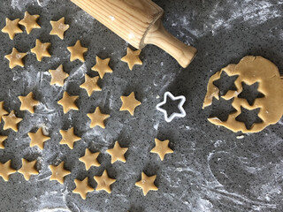 baking day photo from above making mini star shaped biscuits cookies photo with flour cut out shapes