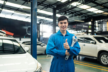 Portrait of Asian handsome automotive mechanic men standing in garage.  
