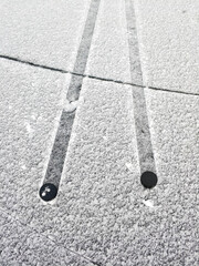 Two pucks on snowy ice.