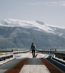 Girl with a Skateboard on a bridge