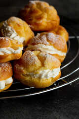 Profiteroles ,Cream Puffs or Choux pastries. French dessert made from choux pastry that is baked, cut in half and filled with whipped cream