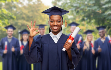 education, graduation and people concept - happy graduate student woman in mortarboard and bachelor...