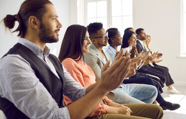 Happy multiethnic diverse people clap hands meet speaker or presenter at meeting or seminar in...