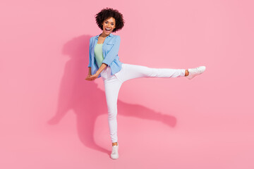 Photo of funny carefree crazy lady hold hands dance party event wear denim shirt isolated pink...