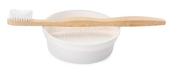 Bowl of tooth powder and brush on white background