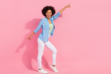 Photo of charismatic nice excited promoter direct finger blank space wear denim shirt isolated pink color background