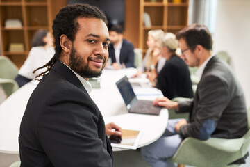 Happy business woman with clipboard in meeting
