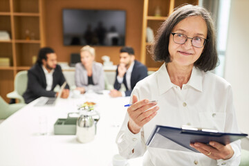 Elderly business woman with clipboard and checklist