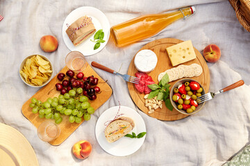 leisure and eating concept - close up of food and drinks on picnic blanket - Powered by Adobe
