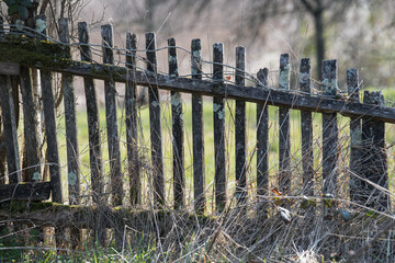 Sunja, Croatia, April 20,2021 : Old dilapidated wooden fence in a rural area.