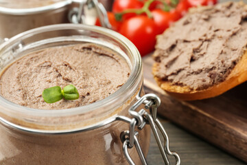 Glass jar with delicious liver pate on table, closeup. Space for text