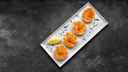 Bruschetta with red caviar, with lemon and green onions