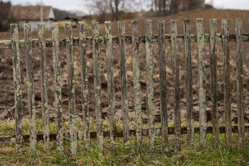 Sunja, Croatia, April 20,2021 : Old dilapidated wooden fence in a rural area.