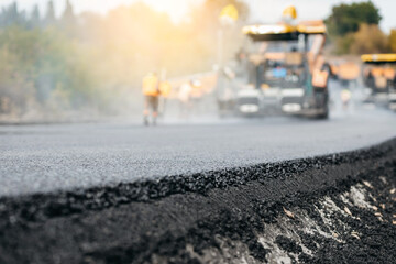 Vibratory asphalt rollers compactor compacting new asphalt pavement. Road service repairs the highway   © andrew_shots