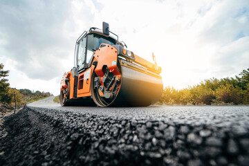 Vibratory asphalt rollers compactor compacting new asphalt pavement. Road service repairs the...