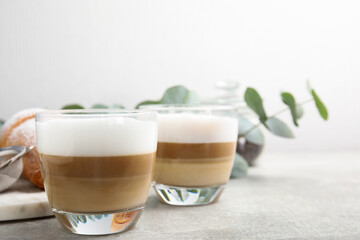 Delicious latte macchiato and croissant on grey table. Space for text