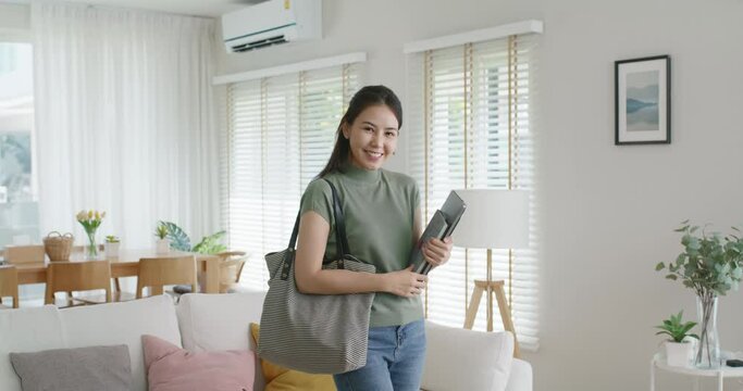Asia people young girl or MBA student happy look at camera carry laptop bag with comfy WFH work wear relax style dress code easy apparel attire prepare cozy outfit ready to reopen day back to office.
