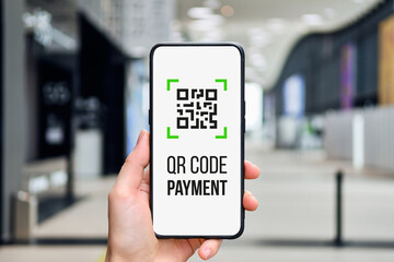 QR code concept. Icon for payment in a smartphone in a person hand.