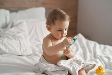 Little baby starting brushing a teeth after the bath
