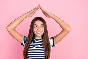 Photo of dreamy cute girl dressed striped clothes showing arms home looking empty space isolated pink color background