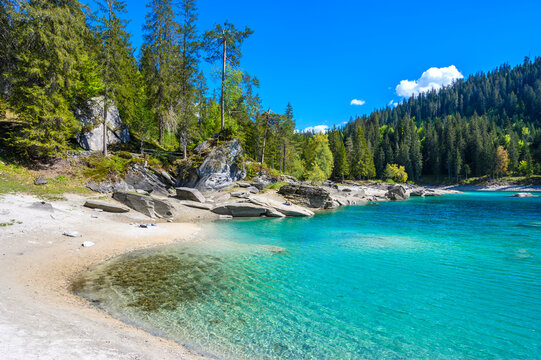 Paradise beach in bay of Cauma Lake (Caumasee) with crystal blue water in beautiful mountain landscape scenery at Flims, Graubuenden - Switzerland