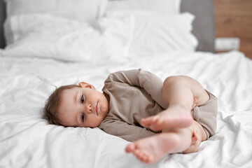 Relaxed caucasian little baby lying in bed