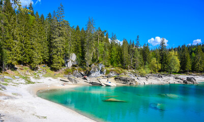 Paradise beach in bay of Cauma Lake (Caumasee) with crystal blue water in beautiful mountain landscape scenery at Flims, Graubuenden - Switzerland