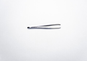 iron tweezers on white background