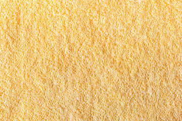 The surface of a bright yellow towel in the form of a beautiful textured abstract background