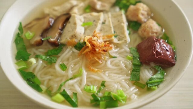 Vietnamese Rice Noodles Soup with Vietnamese Sausage served vegetables and crispy onion - Asian food style