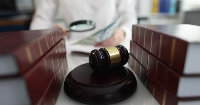 Judge is holding money and magnifying glass