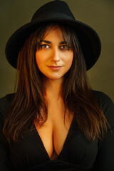  portrait of a woman in a black hat on a warm background - photo