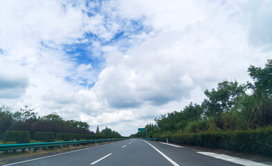 Fototapeta premium Asphalt expressway on a summer day with clouds