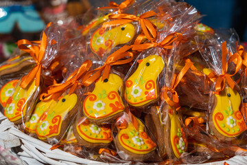 Bright handmade Easter gingerbread in the shape of chickens on the counter of the Easter market in Krakow close-up. Easter sweets handmade. Traditional symbols of Easter. Selective Focus