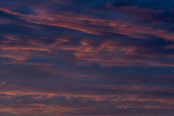 Colorful clouds in the rays of the setting sun