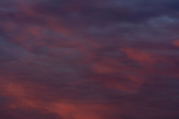 Colorful clouds in the rays of the setting sun
