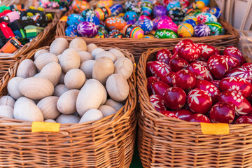 Obraz na płótnie Canvas Baskets of handmade Easter eggs on the counter of the Easter market in Krakow. Spring holiday background. Traditional symbols of Easter. selective focus