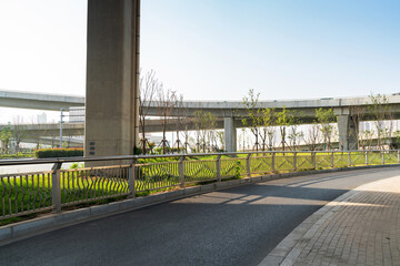 Concrete structure and asphalt road space under the overpass in the city