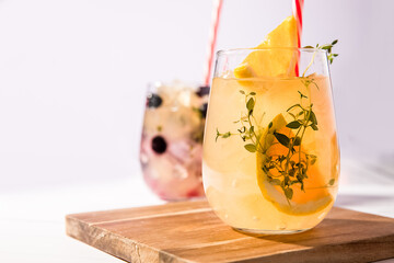 infused water with citrus orange or lemon and blooueberriy in a drinking glasses, healthy eating, dieting, detox concept