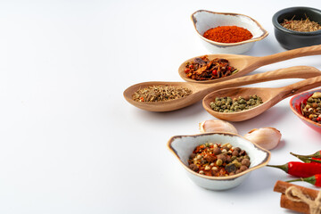 Variety of cooking spices on white background.