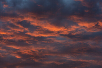 Naklejka na ściany i meble Colorful clouds in the rays of the setting sun