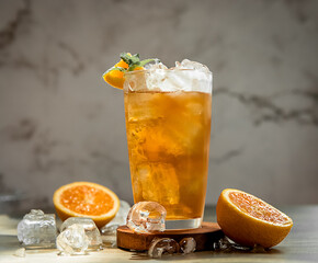fresh home made orange lemonade or kombucha in tall glass over grey background, healthy eating,...