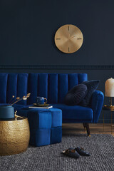 Elegant modern living room interior design with glamour blue velvet sofa, pouf, black metal shelf,...
