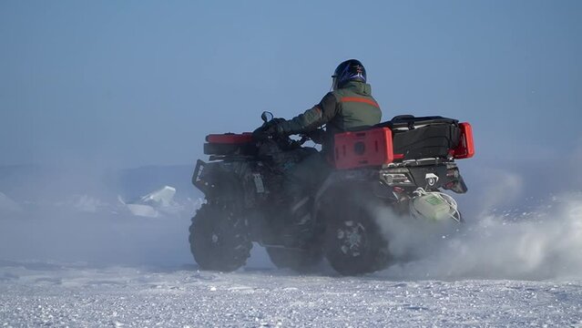 atv-riders drift in the snow