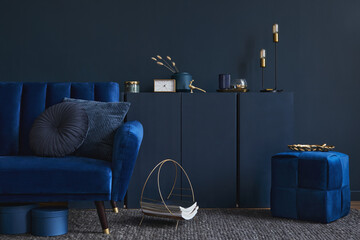 Stylish living room interior composition with velvet blue sofa, wooden commode, pouf and elegant...