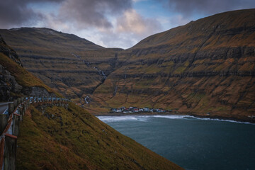 Picturesque landscape with spectacular view to village Tjornuvik Tjornevig on Island Streymoy of the Faroe islands. View to legendary sea stacks Risin og Kellingin.The Giant and the Witch. November 21