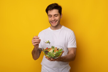 Portrait of Smiling Guy Holding Bowl With Salad