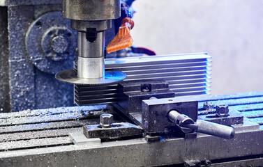 Cutting aluminium billet with machine.  .Circular milling machine cutting metal profile..Steel industry.